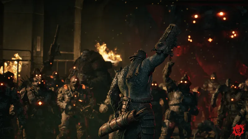 Two Gears stand back-to-back in a burning urban inferno at night, flames and embers swallowing the ruined skyline behind them